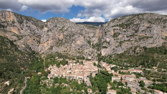 Moustiers one of the beautiful villages of France built on the side of a limestone cliff aerial 