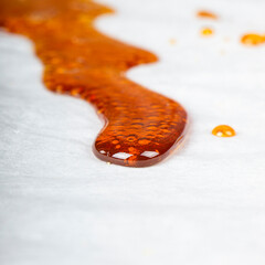 bho extract golden cannabis distillate wax for smoking vape in a glass container