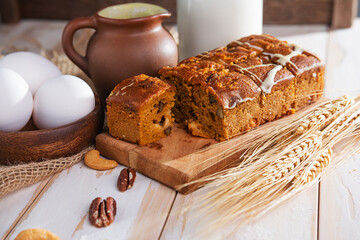 fresh, homemade cupcake with raisins, a bottle of milk and eggs on the table. Close-up.