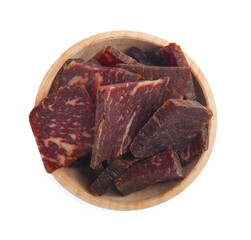 Obraz premium Delicious beef jerky in wooden bowl isolated on white, top view