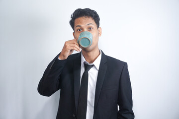 Happy businessman drinking coffee