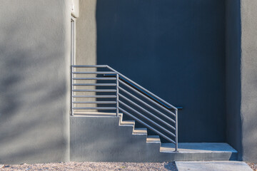 Side view of concrete steps and railing leading to an entrance in a modern building