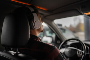 one man with headphones sit in the car listen guided meditation