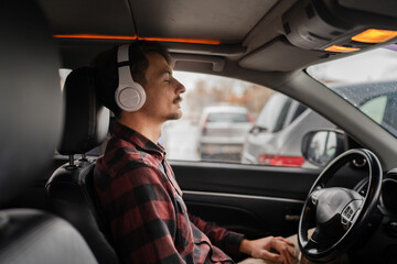 one man with headphones sit in the car listen guided meditation