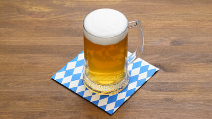 Banner Oktoberfest Mug of beer on a napkin with a blue and white symbolic pattern beer and food festival, an annual German festival