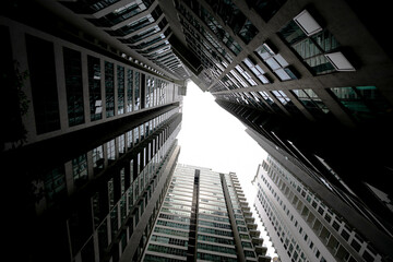 Fototapeta premium Low angle shot of modern glass city buildings with clear sky background. 