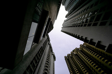 Fototapeta na wymiar Low angle shot of modern glass city buildings with clear sky background. 
