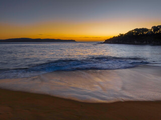 Aerial sunrise seascape with calm seas and a clear sky