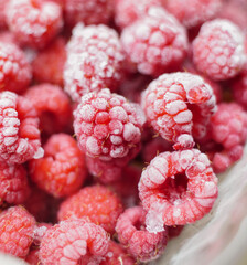 Plastic tray with frozen raspberries. Summer frozen berries