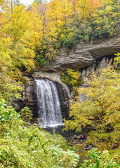 Colorful autumn foliage adds to picturesque Looking Glass Falls on Looking Glass Creek, North Carolina.