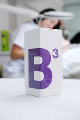 Cosmetic with vitamin B3 are on the table against the backdrop of the cosmetologist's office.