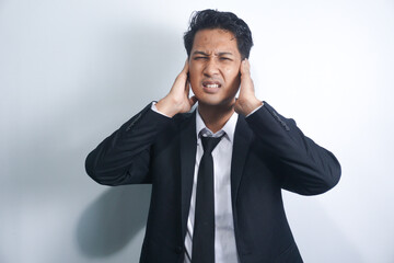 Unhealthy young asian man suffering from sudden throbbing ear ache.