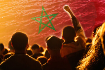 Defocus Morocco football team. supporters on stadium. Morocco flag and football fans celebrating victory. Protest in Morocco. Rise hand. Out of focus
