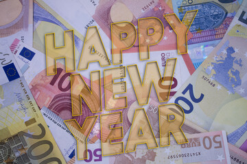 Fototapeta premium Happy New Year word with money. Paper currency background with different banknotes.