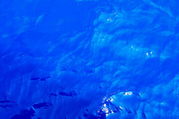 Very nice sea water background or backdrop with selective focus. Small waves of natural water surface texture.