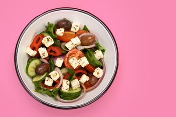 Greek salad  on color background.