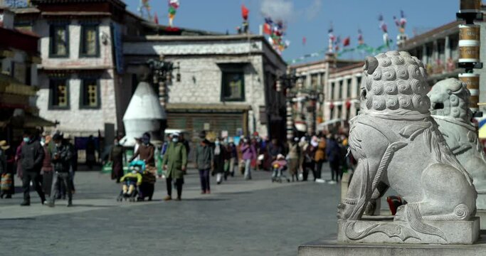 Tibet, Lhasa, China, People walking along the ancient Barkhor street Bakuo W street in summer day in cloudy we