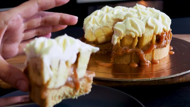Banoffi cake made of shortbread, bananas and homemade caramel, cake with bananas, caramel and cream , cut a piece
