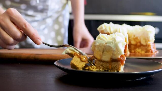 Banoffi cake made of shortbread, bananas and homemade caramel, cake with bananas, caramel and cream , cut a piece