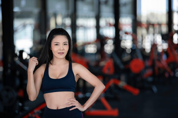 Obraz na płótnie Canvas Close up asian beautiful sportswoman wear sport bra on wall of gym,Thailand love health,Slim woman workout concept