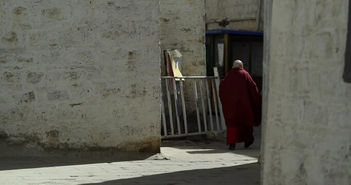 Tibet, Lhasa, China, People walking along the ancient Barkhor street Bakuo W street in summer day in cloudy we
