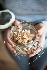 a retro glas jar with christmas gingerbread in girl hands sweet gift in christmas mood