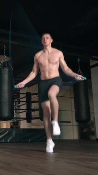 Athletic man skipping with a jump rope. Vertical video