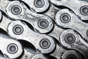 Obraz premium View of Shiny Dirty Greasy Oiled Bicycle Chain As A Part of Metal Bicycle Equipment On Grey Tile Stony Background With Contrast Details