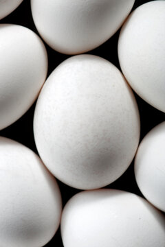 White eggs on a black table.
