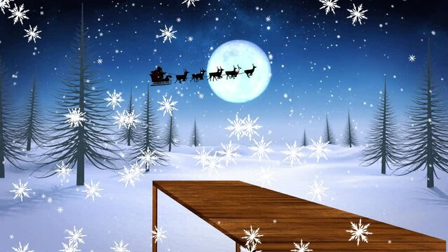 Animation of santa claus in sleigh with reindeer over snow falling and winter landscape