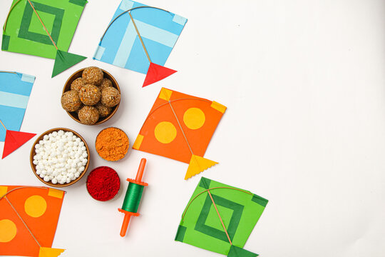 Happy Makar Sankranti, Pongal and Uttarayan with Kite, haldi kum kum bowls and tilgul sweets