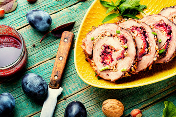 Juicy roasted porchetta with plums