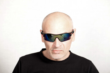 portrait of a man in sunglasses on a gray background