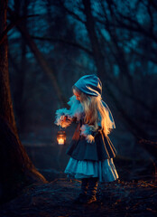 Girl with candle in the night forest