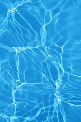Defocus blurred transparent blue colored clear calm water surface texture with splashes and bubbles. Trendy abstract nature background. Water waves in sunlight with copy space. Blue watercolor shining