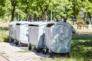 Garbage cans in the city park. Garbage container in a public park. Environment, city life, sanitary standards