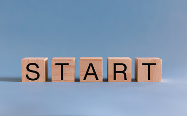 The word start on wooden cubes. To make a new start in life, business, education or career concept.
