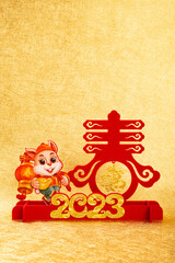 Chinese New Year of Rabbit mascot on golden background at vertical composition the Chinese words means springtime and fortune no logo no trademark