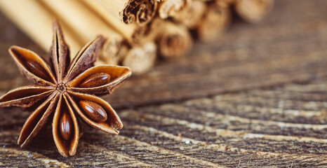 cinnamon sticks and anise on a wooden background