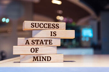 Wooden blocks with words 'Success is a state of mind'.