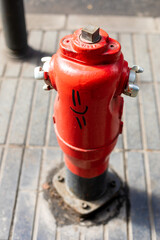 red fire hydrant with a happy face graffiti