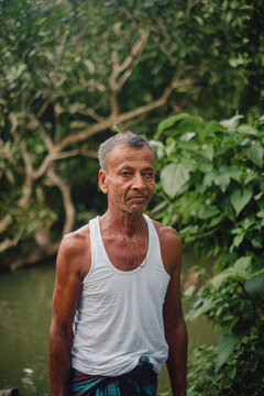 South asian village old man standing in a green environment 