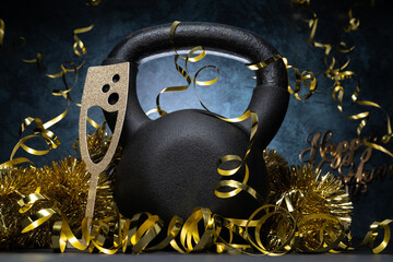 Heavy kettlebell and golden decorations, party streamers for New Year's Eve celebration, birthday...