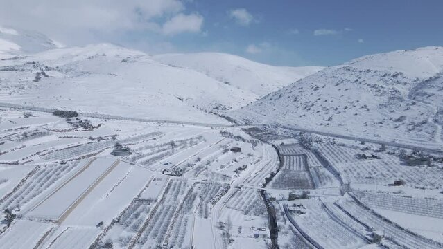 Establishing shot of a snow-covered Mount Hermon in Israel