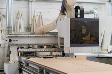 Wood CNC machine at carpentry workshop. Production line of the wooden factory. CNC automatic...