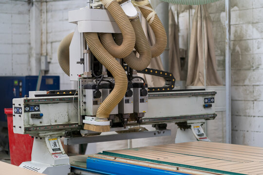 Wood CNC machine at carpentry workshop. Production line of the wooden factory. CNC automatic woodworking machine in manufacturing industry