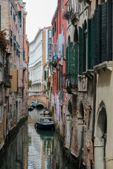 Fototapeta na wymiar Glimpse with boats in the navigable canal among the houses of the island of Venice