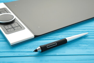 Graphic designer using digital tablet on blue background