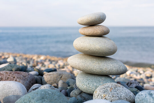 Stack of zen stones in harmony and balance with sea view
