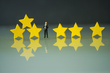 Miniature businessman choose stand with three star. Customer review satisfaction feedback survey...